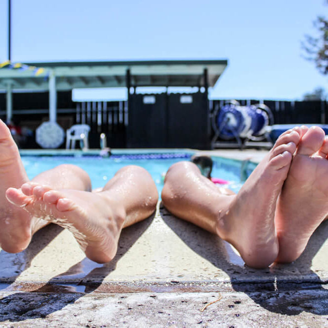 A couples feet emerging out of a pool getting intuitive counsel to improve their relationship