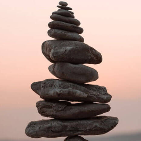 Like these rocks balanced on each other become more grounded, whole and balanced throuugh spiritual, psychic, intuitive theta healing with Colby Wilk