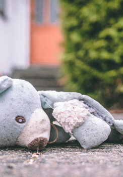Torn teddy bear on ground suggesting a need to heal trauma through intuitive, psychic, faith, theta healing with Colby Wilk