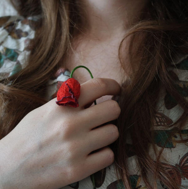 Woman holding wilting rose to her chest suggesting depression and a need for intuitive, psychic healing work with Colby Wilk, Seattle WA