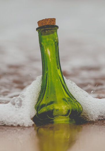 Bottle on beach in water